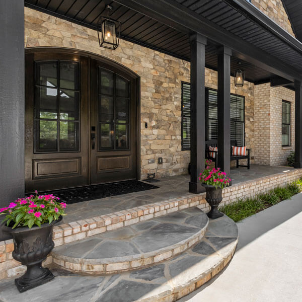 custom stone porch with a bench seat
