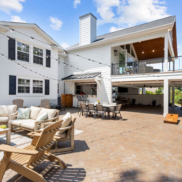 large outdoor patio with several patio furniture sets