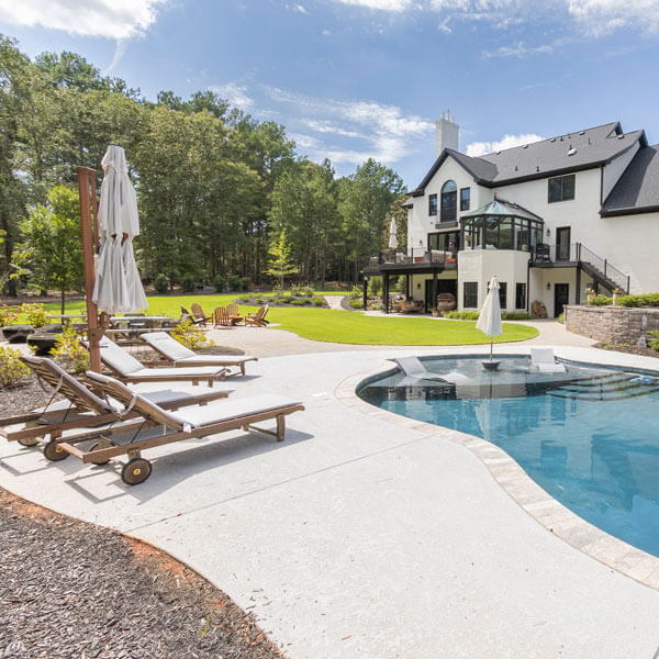 view of swimming pool overlooking a three-story house