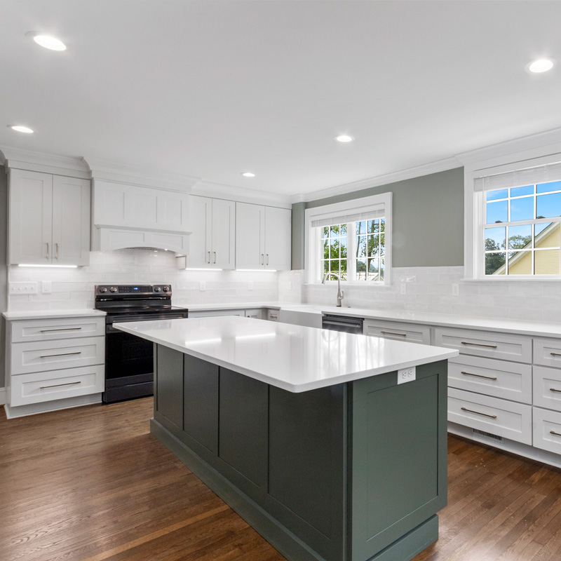 green kitchen island and white cabinets
