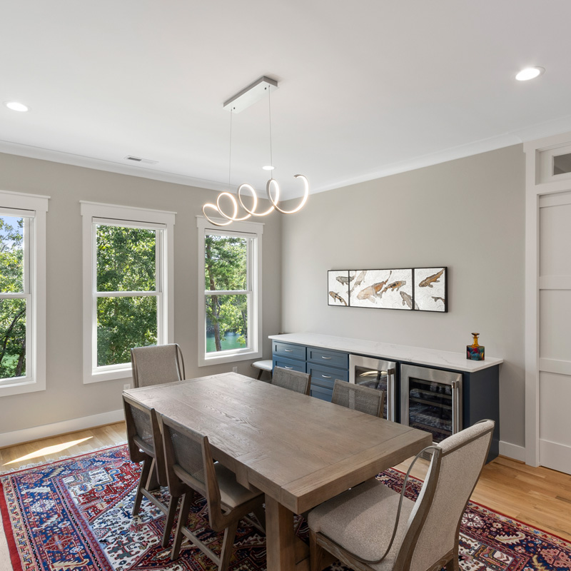 dining room with a table and three windows
