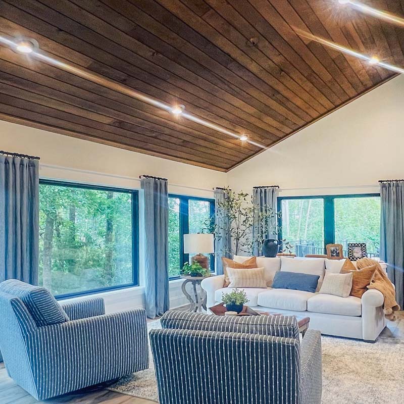 Family room with many windows by Mosteller Construction